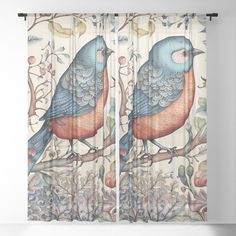 two blue birds sitting on top of a tree branch in front of a floral background