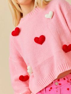 a woman in pink sweater with hearts on it