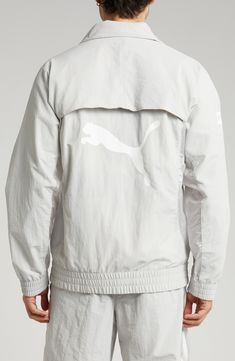 This relaxed-fit track jacket is part of a collab with PLEASURES and is inspired by a clash of racing and punk-inspired streetwear. Bold tonal branding for both labels subtly reflects against the sleek nylon on the outerwear, while underarm ventilation keeps it breathable throughout the day. 28" length (size Medium) Front zip closure Stand collar Elastic cuffs and hem Side zip pockets Underarm ventilation Water-repellent 100% recycled nylon Machine wash, tumble dry Imported PUMA has received the Reflective Track Jacket For Streetwear, Sporty Track Jacket For Spring Streetwear, Sporty Spring Track Jacket For Streetwear, Fall Streetwear Track Jacket With Reflective Details, Reflective Long Sleeve Track Jacket For Streetwear, Casual Long Sleeve Outerwear With Reflective Logo, Reflective Long Sleeve Windbreaker For Streetwear, White Windbreaker With Reflective Details For Streetwear, White Streetwear Windbreaker With Reflective Details