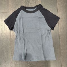 Raglan Baby Tee. Black & Grey. Fitted. Nwot. Sporty Gray Top With Raglan Sleeves, Unisex Sporty Crew Neck Tops, Black Unisex Short Sleeve Tops, Basic Unisex Black Tops, Basic Black Unisex Tops, Black Relaxed Fit Tops With Raglan Sleeves, Brady Melville, Tops Brandy Melville, Baby Tees