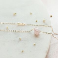 "Classy and delicate. These are the words to describe this dainty Freshwater Pearl and Rose Quartz layered necklace. It is the perfect gift for your bridal party because each Rose Quartz crystal is uniques, just like each of your bridesmaids. Or snag this for yourself! (You deserve it!) Two necklaces in one? You can't beat it! * M A T E R I A L S * 5 small Freshwater Pearls, 1 Rose Quartz Nugget, 14k Gold Fill, 14k Rose Gold Fill, or Sterling Silver chain and findings that are safe on sensitive Dainty Charm Necklace For Mother's Day Party, Dainty Crystal Necklaces For Gifts, Dainty Crystal Necklace For Gift, Delicate Crystal Necklace With Adjustable Chain, Feminine Gold Necklaces For Bridesmaid Gift, Delicate Pink Necklace For Bridesmaid Gift, Delicate Crystal Wedding Necklaces, Dainty Delicate Chain Jewelry For Birthday, Delicate Crystal Necklace As Gift