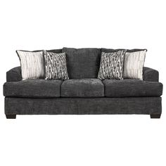 a gray couch with three pillows on it