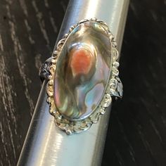 An antique Blister pearl early 1900s sterling ring.  Size 6 3/4.  Condition I see no problems, center choice conch shell in high relief is bezel set, marked sterling.  Scalloped sterling gallery frames this lustrous treasure from the sea.  Art nouveau shank 1 1/8" north to south on finger. Handmade Vintage Oval Pearl Ring, Vintage Silver Oval Pearl Ring, Antique Oval Pearl Ring Collectible, Vintage Oval Sterling Silver Pearl Ring, Handmade Vintage Pearl Ring In Sterling Silver, Vintage Oval Pearl Ring In Sterling Silver, Handmade Vintage Sterling Silver Pearl Ring, Antique Silver Pearl Ring, Antique Silver Oval Pearl Ring