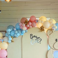 there is a teddy bear and balloons on the wall with it's name written