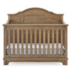 a wooden crib with white sheets on the bottom and bottom bed, in front of a white background