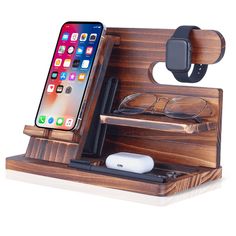 an iphone and some glasses on a wooden docking station with a cell phone in it