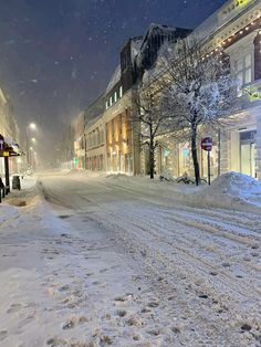 a snow covered street in the middle of winter