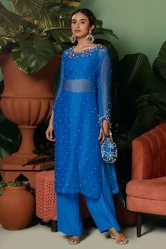 Cobalt blue kurta with sequin, pearl, cutdana, stone embellished in floral pattern. Paired with bustier and pant.
Components: 3
Pattern: Embellished
Type Of Work: Sequin, pearl, cutdana, stone
Neckline: Boat neck
Sleeve Type: Full sleeves
Fabric: Kurta: Organza, Pant: Crepe, Bustier: Shantoon
Color: Blue
Other Details: 
Length:
Kurta: 46 inches
Note: Potli shown in the image is not for sale
Occasion: Sangeet - Aza Fashions Full Sleeve Kurti Designs, Boat Neck Kurti, Bali Outfits, Mahima Mahajan, Suits For Women Indian, Brocade Lehenga, Yellow Kurta, Desi Outfits, Trendy Outfits Indian