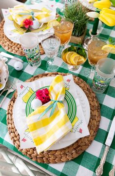 the table is set with plates, napkins and glasses