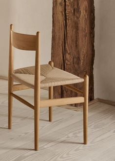 a wooden chair sitting next to a piece of wood