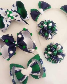 several pieces of green and white hair accessories on a table with polka dots, bows, and ribbons