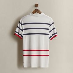 Part of the Spring 1992 Polo Stadium collection. Made in America. Striped interlock Polo shirt with a logo at the front. Size large has approximately a 29" back body length a 19.25" shoulder and a 46" chest. White Polo T-shirt With Striped Collar, White Jersey Tops With Three Stripes, Classic White T-shirt With Contrast Stripes, Retro White Top With Ribbed Collar, White Retro Top With Ribbed Collar, White Polo Top With Striped Collar, White Polo Collar Top With Striped Collar, Casual Three-stripes Golf Tops, Casual Golf Tops With Contrast Stripes