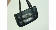 "Really cute 1970s handbag in navy blue leather, with buckled straps. Flap closure with brass snap closure. The interior has one compartment and three pockets - one zippered. No maker's labels present. Condition shows some wear but overall good. It measures 10.25\" wide, 6.5\" high, 2.25\" deep, with 6\" handle drop. * Proud member of the Vintage Fashion Guild * For more vintage fashions, visit Vintage Runways' shop at http://www.vintagerunway.etsy.com. Follow on Instagram - instagram.com/vtgrun Vintage Shoulder Bag With Metal Hardware For Office, Vintage Office Shoulder Bag With Metal Hardware, Vintage Shoulder Bag With Hasp Closure For Office, Vintage Formal Satchel With Metal Hardware, Vintage Shoulder Bag With Metal Hardware For Everyday, Everyday Vintage Shoulder Bag With Metal Hardware, Leather Shoulder Bag With Hinge Closure, Leather Shoulder Bag With Hinge Closure For Everyday Use, Vintage Blue Satchel