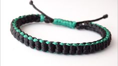 a black and green bracelet with two strings