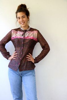 Lovely vintage 70s floral blouse in black with floral print in pink red yellow and green, buttons down, neck tie, polyester, somewhat sheer, original tag intact, aside from minor signs of wear, good vintage condition, clean, ready to wear.** Model is 5'8" and size S for reference  Tag size: 44Approximate size: S/M - please refer to the measurementsM E A S U R E M E N T S -were taken with garments laying flat, please double where necessary.————————————♥————Bust: 18.5"- 47 cmShoulder to Shoulder: Vintage Tie Neck Tops For Spring, Fitted Floral Print Blouse With Tie Neck, Retro Pink Button-up Blouse, Retro Pink Blouse With Buttons, Retro Fitted Tie-neck Top, Spring Retro Tie Neck Tops, Vintage Pink Shirt With Floral Print, Vintage Pink Floral Print Shirt, Spring Retro Tie-neck Tops