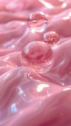 two bubbles floating on top of pink liquid