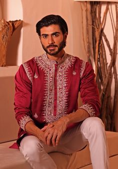 Elevate your style with the Crimson Red Embroidered kurta set. This stunning Red kurta features intricate embroidery, including beads, mirrors, and thread work. With a chinese collar and detailing on the armholes, this kurta is perfect for Sangeet, Mehendi, or as a wedding guest. The set includes white straight fitted pants with buttoned closure, ankle length and side pockets. Composition : Padma Silk Care: Dry Clean Only and Vacuum Storage This product can be customized for sleeves, length and colour Delivery : 4-6 weeks as the product is hand crafted. Check Size Guide or choose MySize for free customisation (All Sizes above XL can be made at 15% additional cost) For more information and sizes please contact fabiliciousfashion@gmail.com or visit our Copenhagen studio. About the Designer : Elegant Embroidered Nehru Jacket For Traditional Ceremonies, Traditional Red Bandhgala For Transitional Season, Traditional Red Fitted Bandhgala, Traditional Fitted Red Bandhgala, Red Fitted Traditional Bandhgala, Traditional Red Ceremonial Sherwani, Traditional Red Bandhgala With Long Sleeves, Traditional Red Long Sleeve Bandhgala, Red Bandhgala With Zari Work For Transitional Season