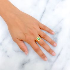 This 22k gold ring, weighing 3.2 grams, boasts a gorgeous green cubic zirconia solitaire, exuding an aura of elegance and charm. The yellow gold finish impeccably complements the verdant hue of the stone, adding a touch of warmth. Available in size 8 with the option for resizing, this ring is perfect for those who adore the luxurious interplay of vibrant color and the timeless allure of gold, offering a distinguished and captivating presence. PRODUCT DETAILS Gold Purity(karat): 22k Item Weight(g Green Diamond Topaz Promise Ring, Green Emerald Cut Topaz Ring With Diamond, Emerald Cut Green Topaz Ring With Diamond, Green Diamond Topaz Ring, Classic Green Cubic Zirconia Halo Ring, Green Topaz Ring With Diamond Accent, Green Topaz And Diamond Anniversary Ring, Green Topaz Diamond Ring For Anniversary, Emerald Cut Green Cluster Ring In 14k Gold