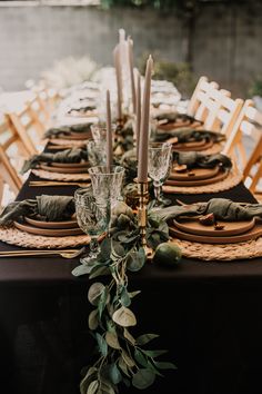 the table is set with candles and place settings