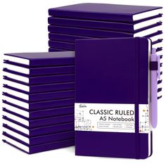 a stack of purple notebooks sitting next to each other