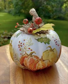 a painted pumpkin sitting on top of a wooden table