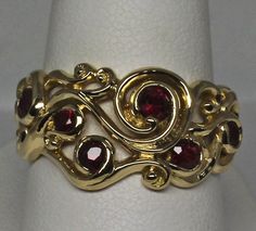 Ruby Swirl ring in 18k yellow gold with natural Rubies size 6.25 The ruby swirl ring design was inspired by the fables surrounding the Arthurian legends. Swirls of gold make up the ring. Rubies burn within the golden swirls invoking the magic that I feel must have been present in the mists surrounding the fabled island. I've set 1.08cts total weight of very fine rubies in this ring. Some of the rubies have a few flaws but nothing that detracts from their beauty. All of the stones are natural and Fine Jewelry Yellow Gold Ruby Ring With Intricate Design, 14k Yellow Gold Ruby Ring With Intricate Design, Unique 14k Yellow Gold Ruby Ring, Unique Yellow Gold Ruby Ring, Gold Make Up, Medieval Rings, Diamond Pendants Designs, Amethyst And Diamond Ring, Swirl Ring