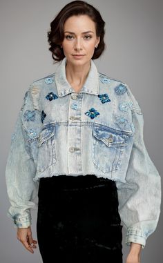 Discover our unique Embroidered cropped Jeans Jacket, a true standout piece for your wardrobe. This jacket is meticulously crafted and adorned with one-of-a-kind embellishments, all made from upcycled materials, ensuring that the piece is 100% sustainable. The cropped silhouette adds a modern twist to this classic denim staple, while the intricate embroidery adds a touch of elegance. Perfect for  day to night adding a statement to any outfit, this jacket is a must-have for eco-conscious consumer Spring Cotton Cropped Denim Jacket, Spring Cropped Cotton Denim Jacket, Fitted Cotton Cropped Jacket For Spring, Spring Fitted Cotton Cropped Jacket, Spring Denim Cropped Jacket, Fitted Cropped Jacket For Spring, Embroidered Long Sleeve Denim Jacket For Summer, Embroidered Long Sleeve Summer Denim Jacket, Embellished Cotton Outerwear For Fall