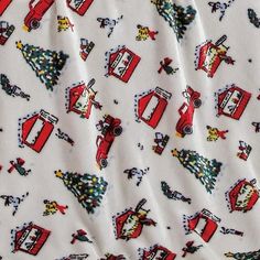 a white fabric with red and yellow firetrucks on it's side