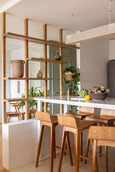 a kitchen with wooden chairs and a white counter top