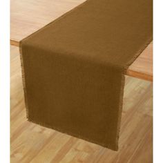 a brown table runner on top of a wooden floor