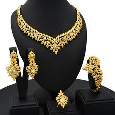 Indulge in luxury with this exquisite Dubai Gold Necklace Set, perfect for wedding parties. With its opulent design and superior craftsmanship, this set features a necklace, bracelet, earrings, and ring. Make a lasting impression and elevate your style with this luxurious jewelry set." Dubai Gold Jewelry Necklaces Bridal Owambe Shop, Luxury Gold Plated Necklace For Festive Season, Dubai Gold Jewellery Design Necklaces, Dubai Gold Necklace, Dubai Gold Jewelry Set, Nigeria Wedding, Dubai Gold Jewelry, Unique Gold Jewelry Designs, Gold Jewelry Set