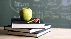 an apple sitting on top of books next to a chalkboard with the words, 7 back - to - school electrical safety tips for your home