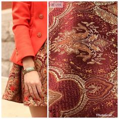 a woman in an orange jacket and skirt with her hand on her hip, standing next to a red paisley print dress