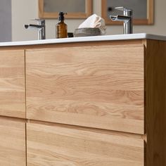 a bathroom vanity with two soap dispensers on it