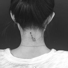 a woman with a small tattoo on her neck and back of the neck is shown