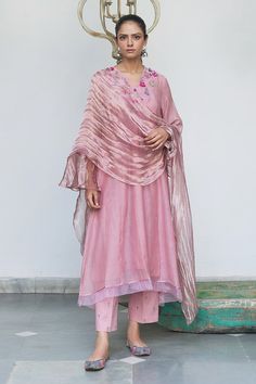 Plum chanderi kurta with 3D organza flowers on the yoke panel in a V-neck. Complemented with a tissue dupatta and hand embroidered pants.
Component: 3
Embroidered
Neckline: V-Neck
Sleeve Length: Three Quarter
Fabric: Kurta: Chanderi; Pant: Cotton; Lining:  Cotton; Dupatta: Tissue
Color: Pink, Purple
A-line silhouette kurta
Attached cotton lining kurta
3D organza tissue flowers, hand embroidery and bullion knots across the yoke
Floral hand embroidered pant
Side slit kurta
Asymmetric hem kurta - A Beige Kurta, Purple Embroidery, Fancy Fits, Chanderi Kurta, Kurta Set For Women, Kurti Designs Latest, Kurti Embroidery Design, Fashion Sketches Dresses, Fashion Vocabulary