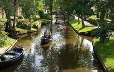 two people in a small boat on a canal