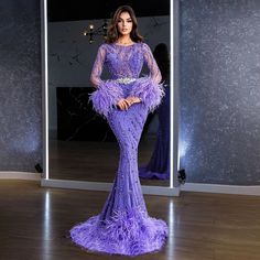 Stunning Mermaid Silhouette: Designed to beautifully enhance the feminine figure, providing a sleek and figure-hugging fit that flares out at the knees. Luxurious Purple Fabric: Crafted from high-quality fabric in a rich purple hue, offering a regal and sophisticated appearance. Intricate Beaded Detailing: Adorned with exquisite beadwork that adds a touch of opulence and elegance. Elegant Feather Accents: Features luxurious feather embellishments for a dramatic and unique look. Graceful Train: I Beaded Feathers, Purple Mermaid, Color Embroidery, Bridal Elegance, Evening Dress Fashion, Full Dress, Sequin Maxi Dress, فستان سهرة, Stunning Gowns