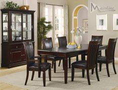 a dining room table with chairs and a china cabinet