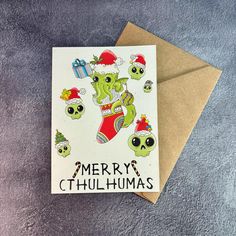 a christmas card with an image of a green creature in santa's hat on it