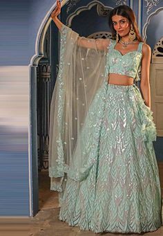 Readymade Net Lehenga in Pastel Blue. This attire with Shantoon Lining is Enhanced with Fancy Dangles, Sequins Work and Scalloped Border. Available with a Sleeveless Net Pastel Blue Choli Crafted in Sweetheart Neck and a Net Dupatta in Pastel Blue. The Choli and Lehenga Lengths are 15 and 42 inches respectively. We sell all kinds of Lehenga and Chaniya Choli Casual Lehenga |Sangeet Lehenga Choli |Wedding Lehenga Choli |Haldi Lehenga Choli |Mehandi Lehenga Choli |Chaniya Choli |Bridal Lehenga Cho Blue Sequined Sets For Reception, Blue Saree Sets With Sequins, Light Blue Semi-stitched Dress With Intricate Embroidery, Semi-stitched Light Blue Dress With Intricate Embroidery, Blue Sequined Sets For Wedding, Blue Sequined Wedding Set, Light Blue Semi-stitched Resham Embroidery Lehenga, Blue Anarkali Set With Sequins For Reception, Blue Sequined Lehenga For Festive Occasions