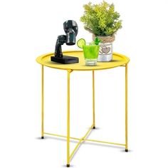 a yellow table with a potted plant on it and a grinder next to it