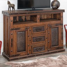 an entertainment center with a television on top of it