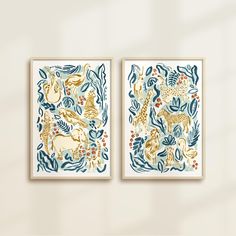 two framed art prints on a wall with plants and animals in blue, gold and white