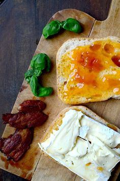 bread, cheese and bacon are on a cutting board