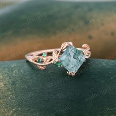 a green stone ring sitting on top of a wooden table