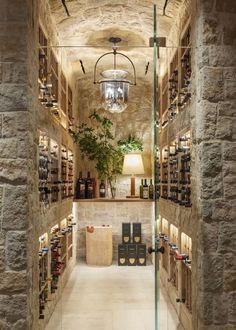 an image of a wine cellar with lots of bottles on the shelves and lights hanging from the ceiling