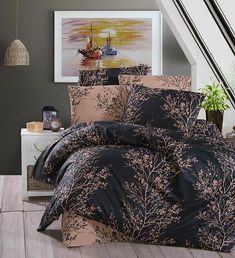 a bed with black and pink comforters in a room