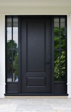 a black front door with two sidelights