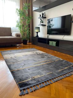 a living room with wood floors and a flat screen tv